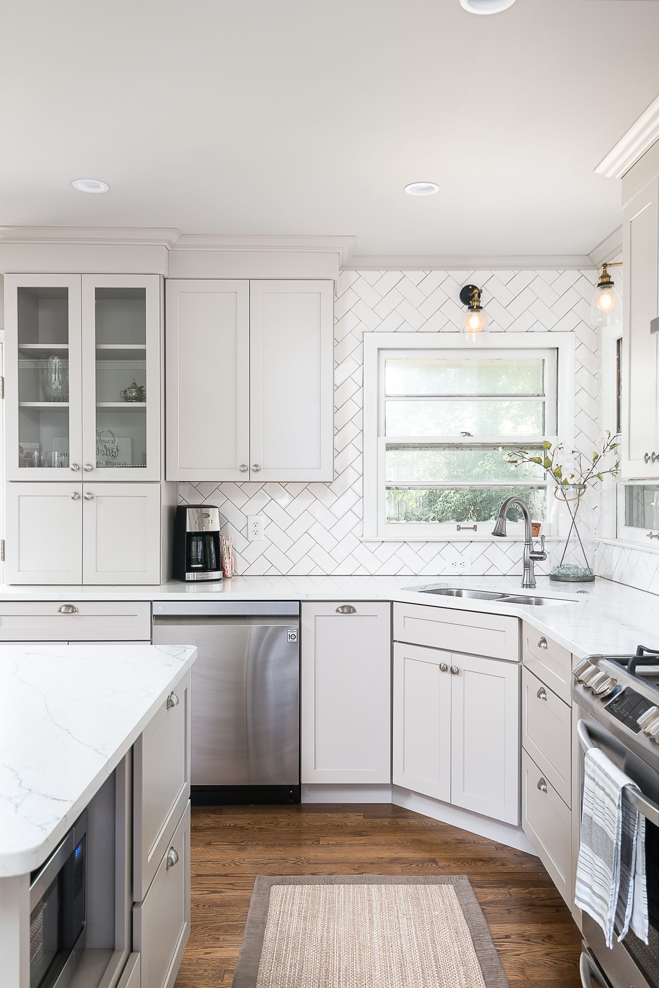 A kitchen with white cabinets and stainless steel appliances.