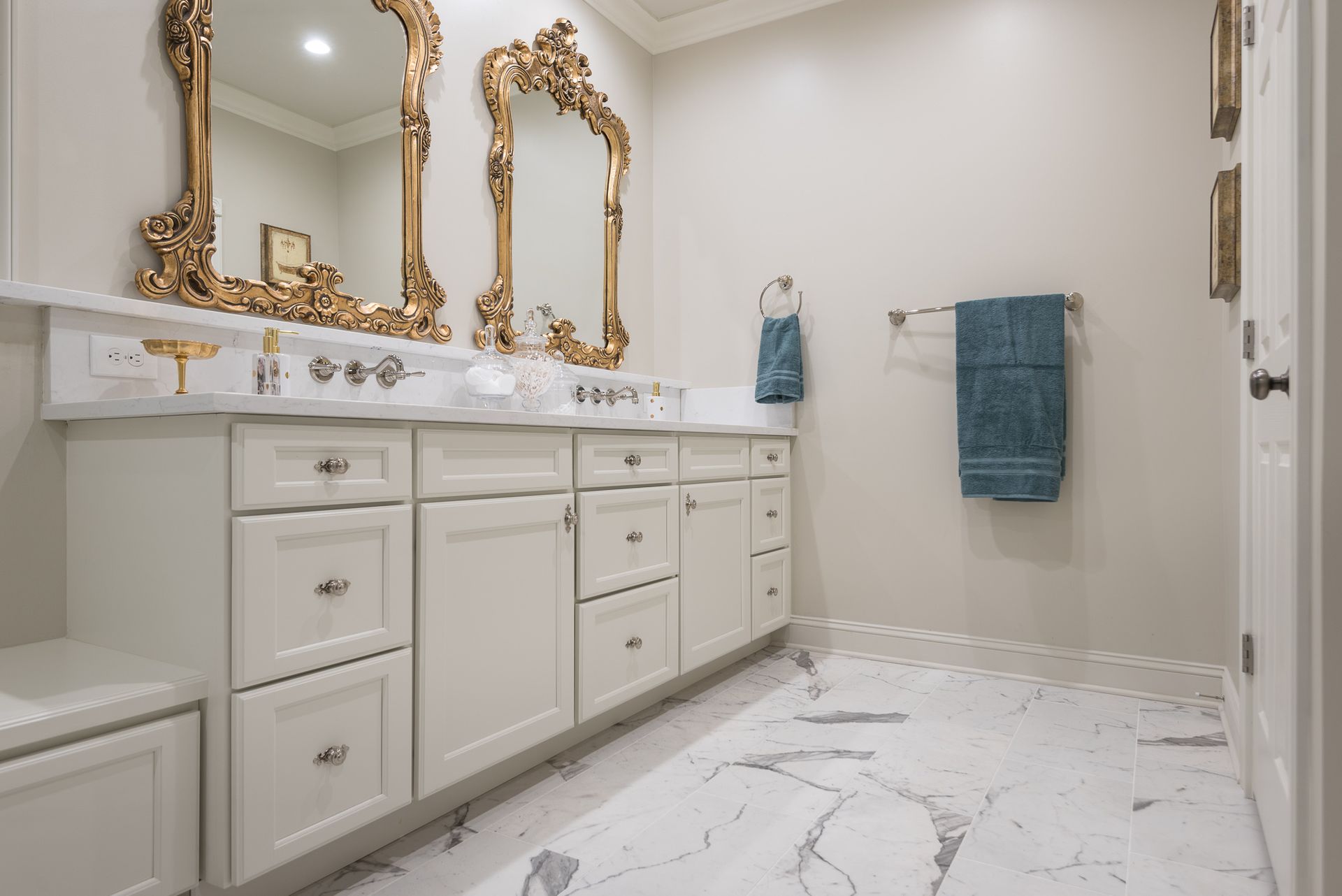 A bathroom with two sinks , two mirrors , and a marble floor.
