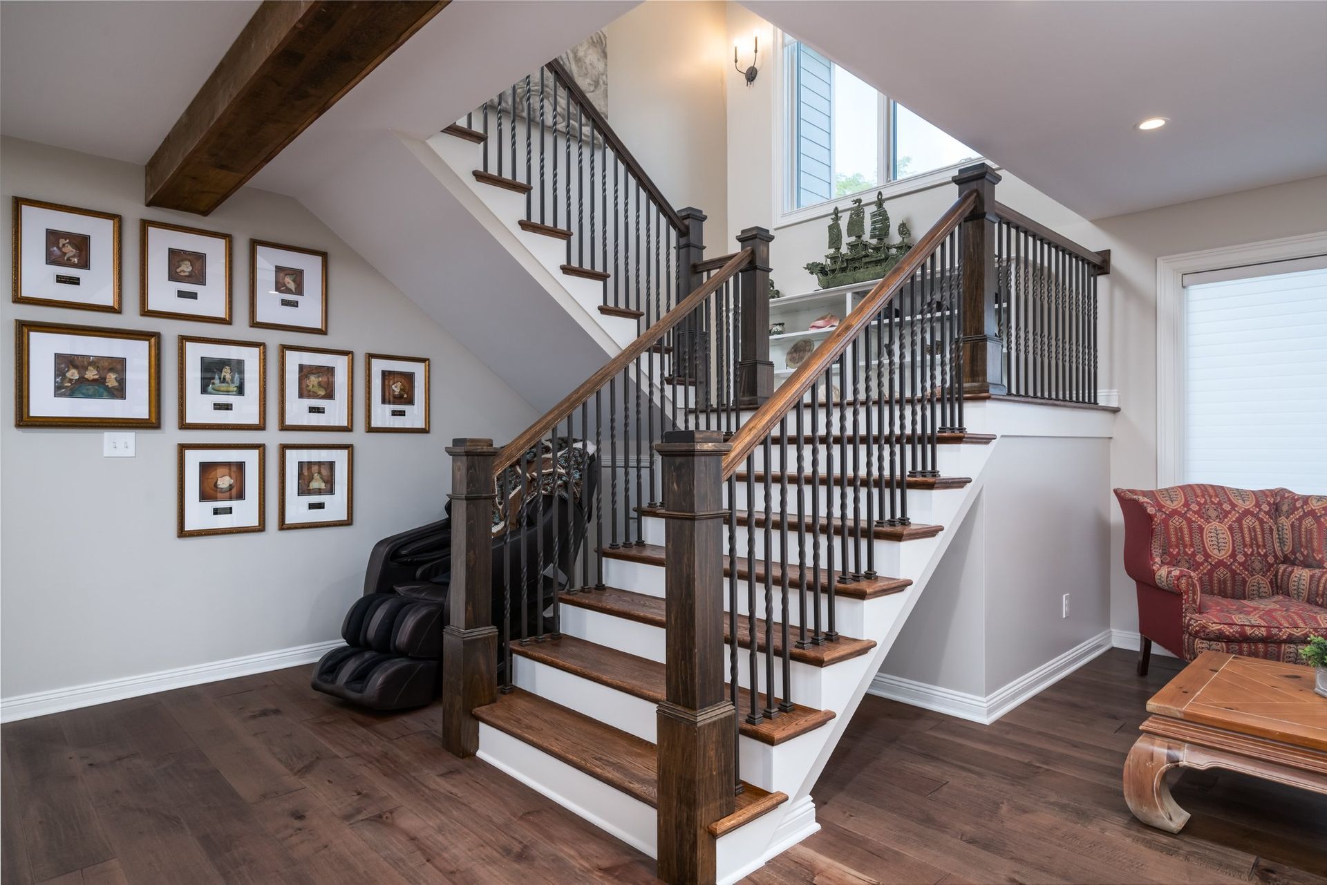 A living room with a staircase leading up to the second floor.