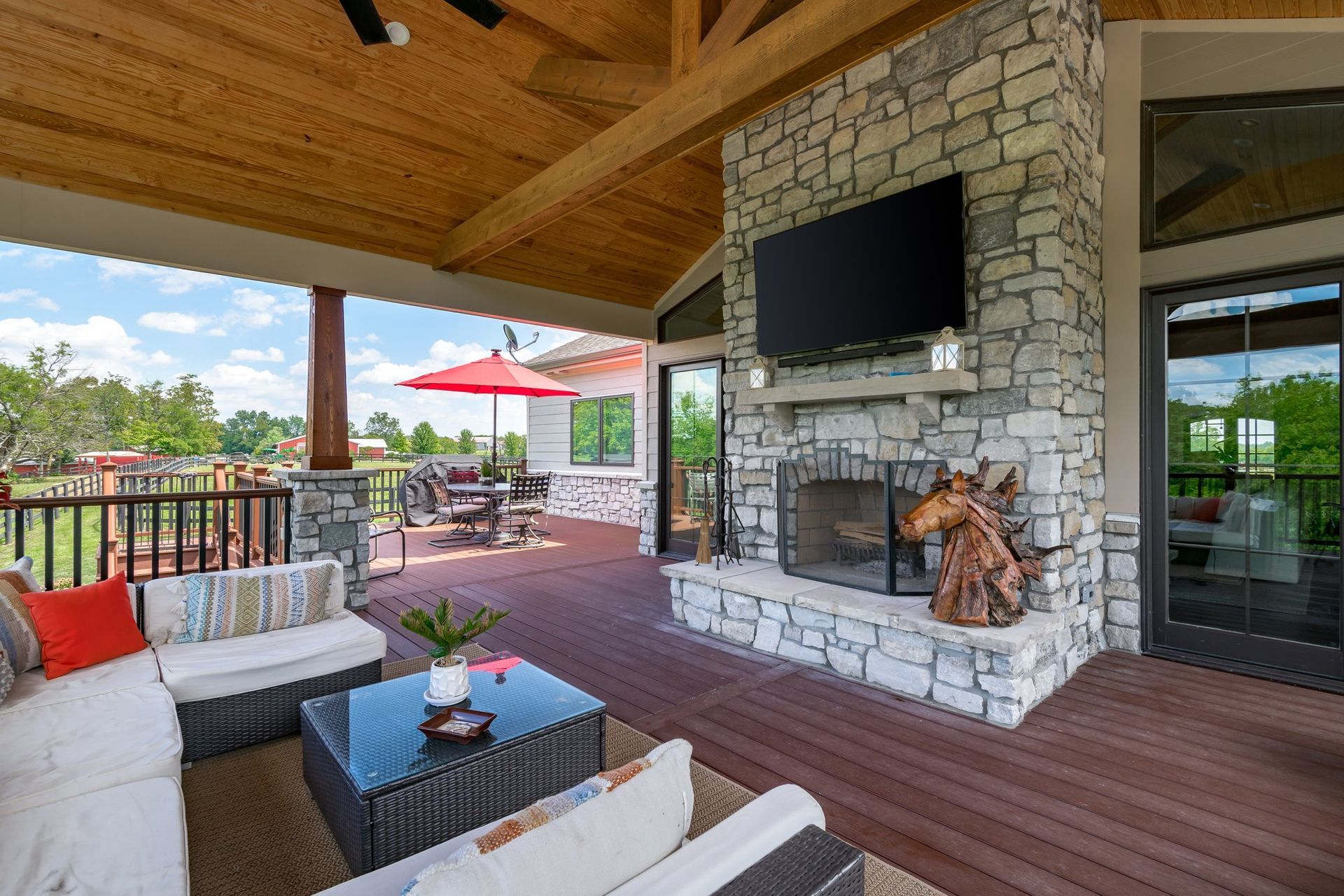 A patio with a fireplace and a flat screen tv.
