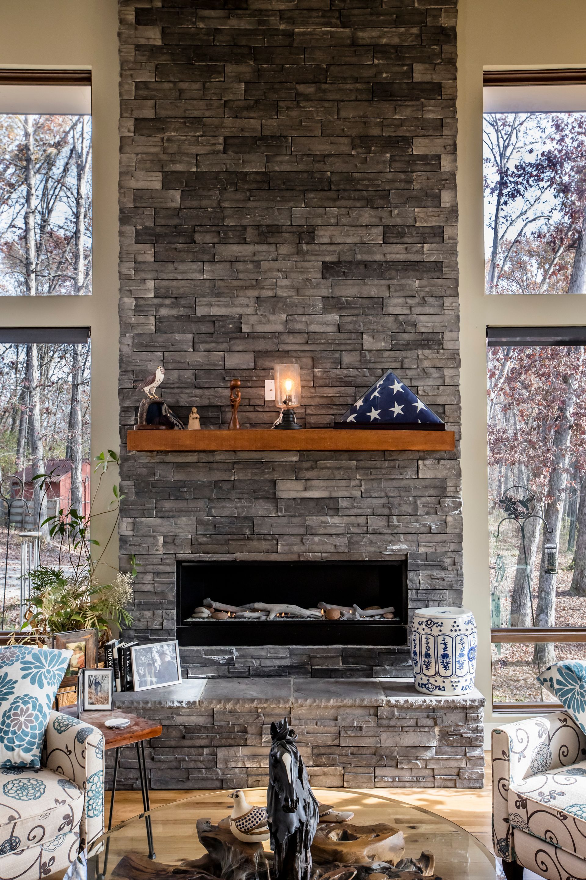A living room with a fireplace and a brick wall.