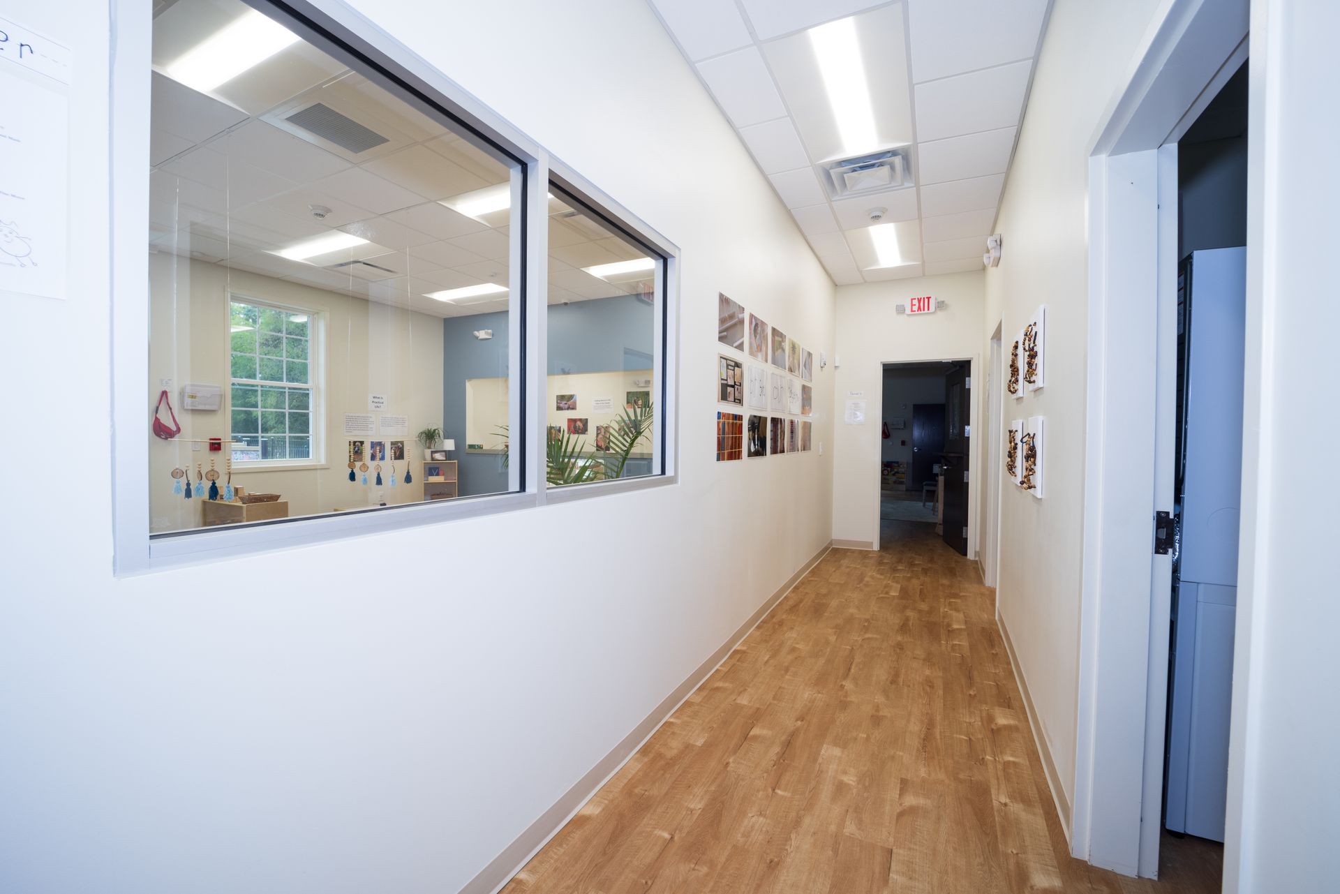 A long hallway with a lot of windows and wooden floors