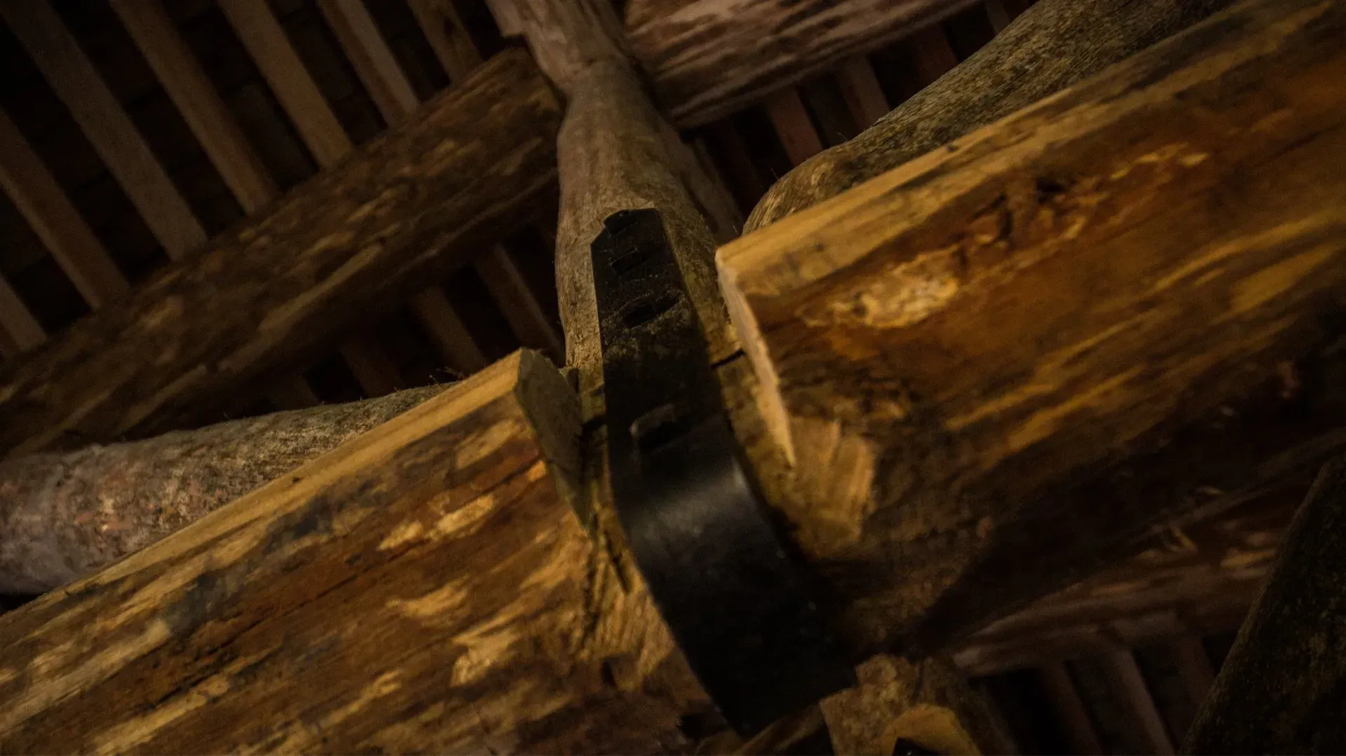 A large piece of wood is being cut with a saw.