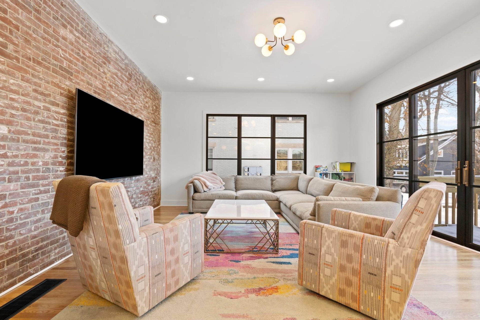 Stylish sitting room in a historic remodel, by Anderson & Rodgers Construction, with exposed brick walls