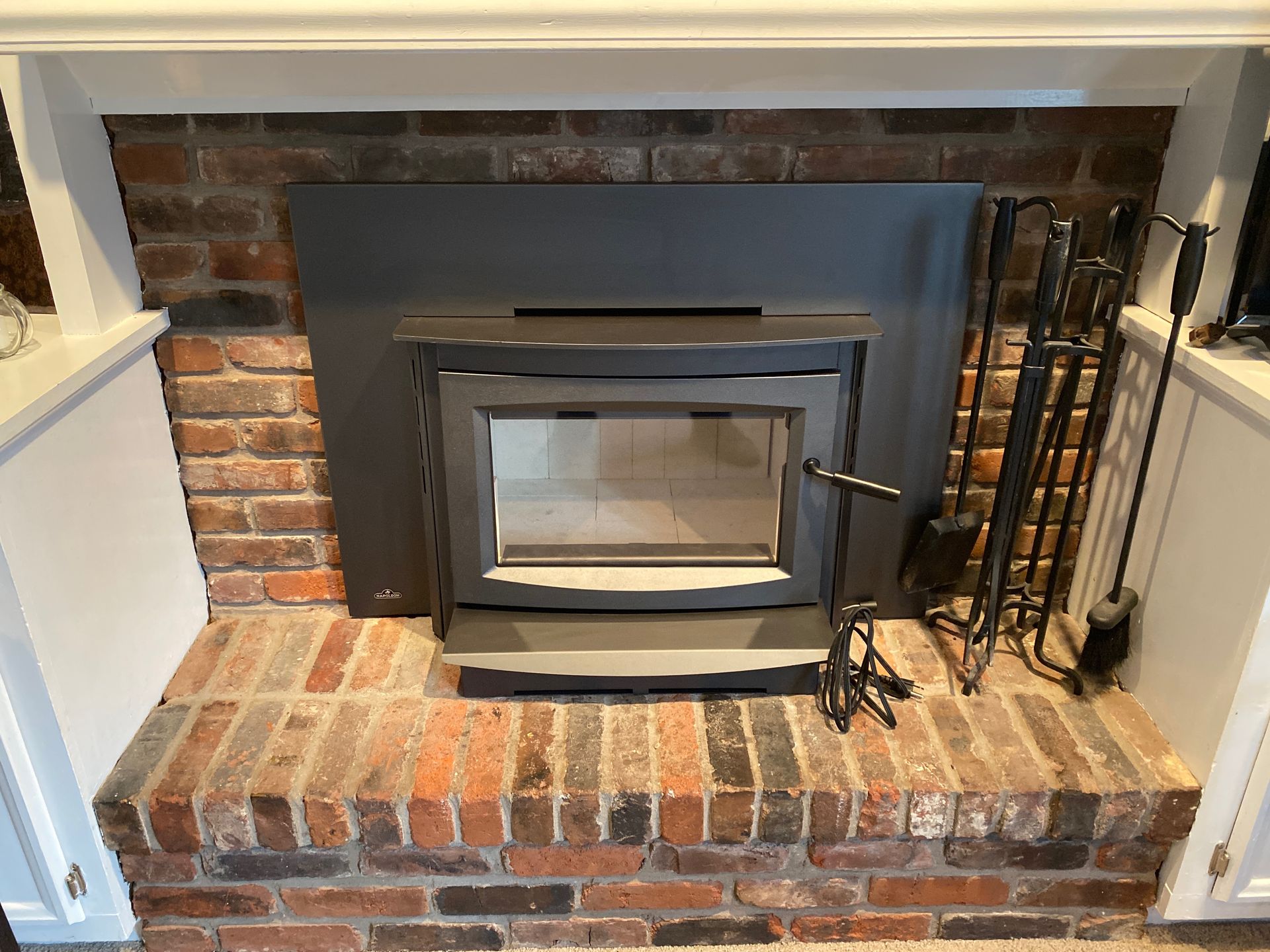 Wood-burning fireplace insert professionally installed in an existing masonry fireplace in a Kentucky home