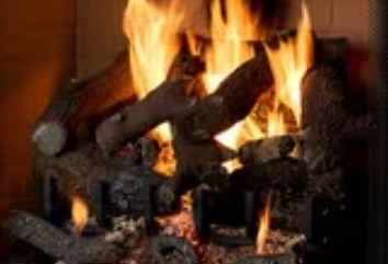 Burning gas logs in a fireplace with bright orange flames