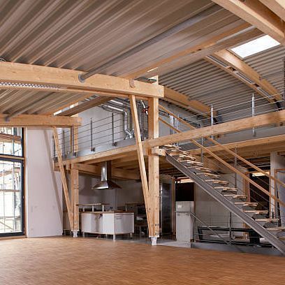 A large empty room with stairs leading up to the second floor.