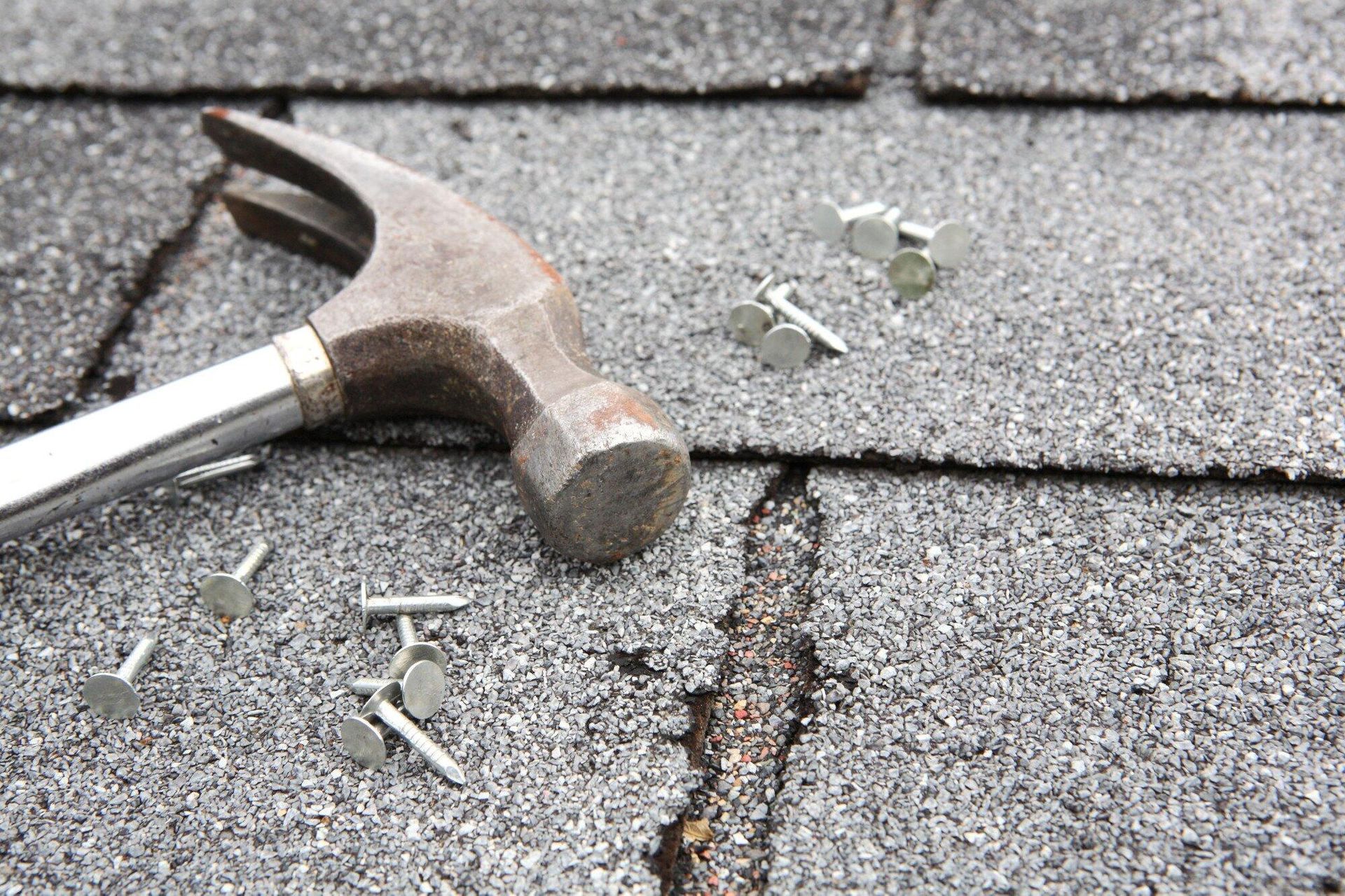 Two men are working on the roof of a house.