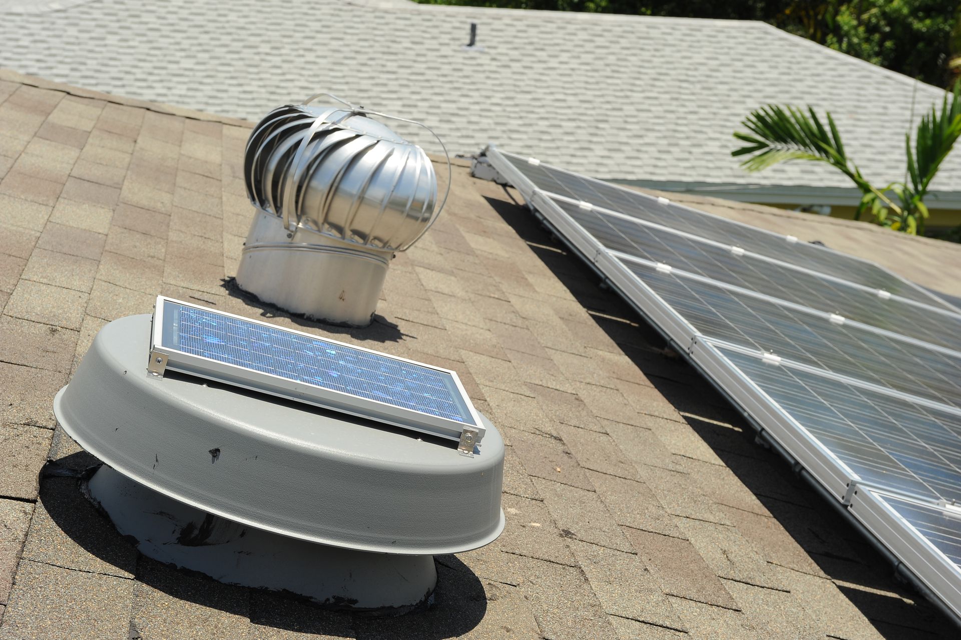 A roof with a fan and solar panels on it