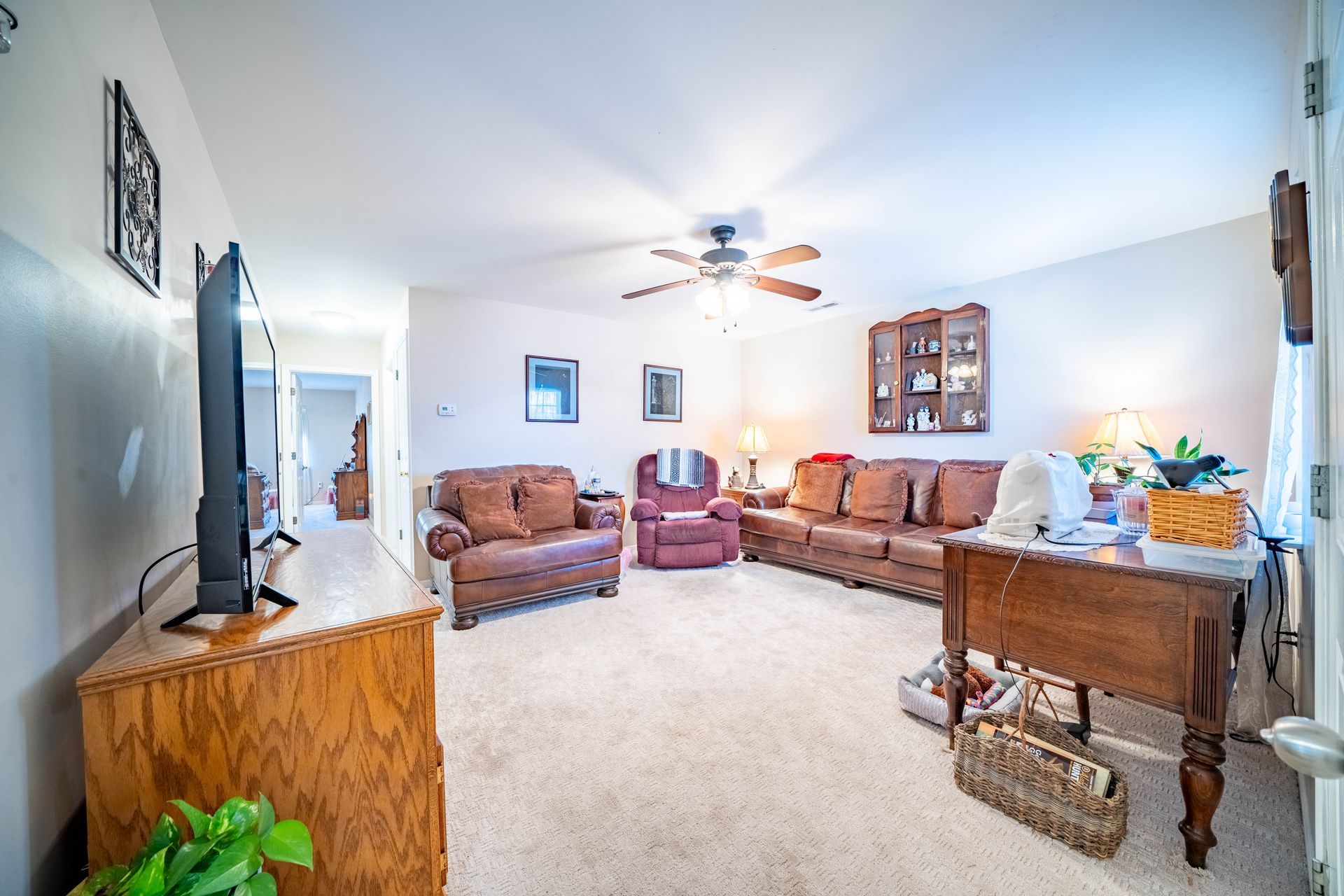 a living room filled with furniture and a flat screen tv .