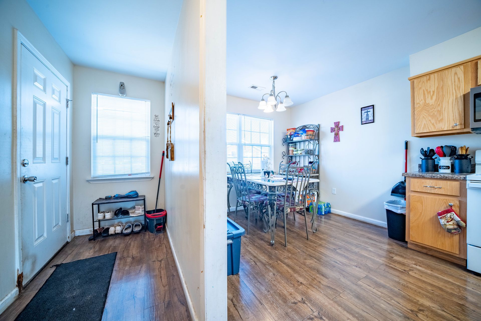 a hallway leading to a kitchen and dining room in a house .