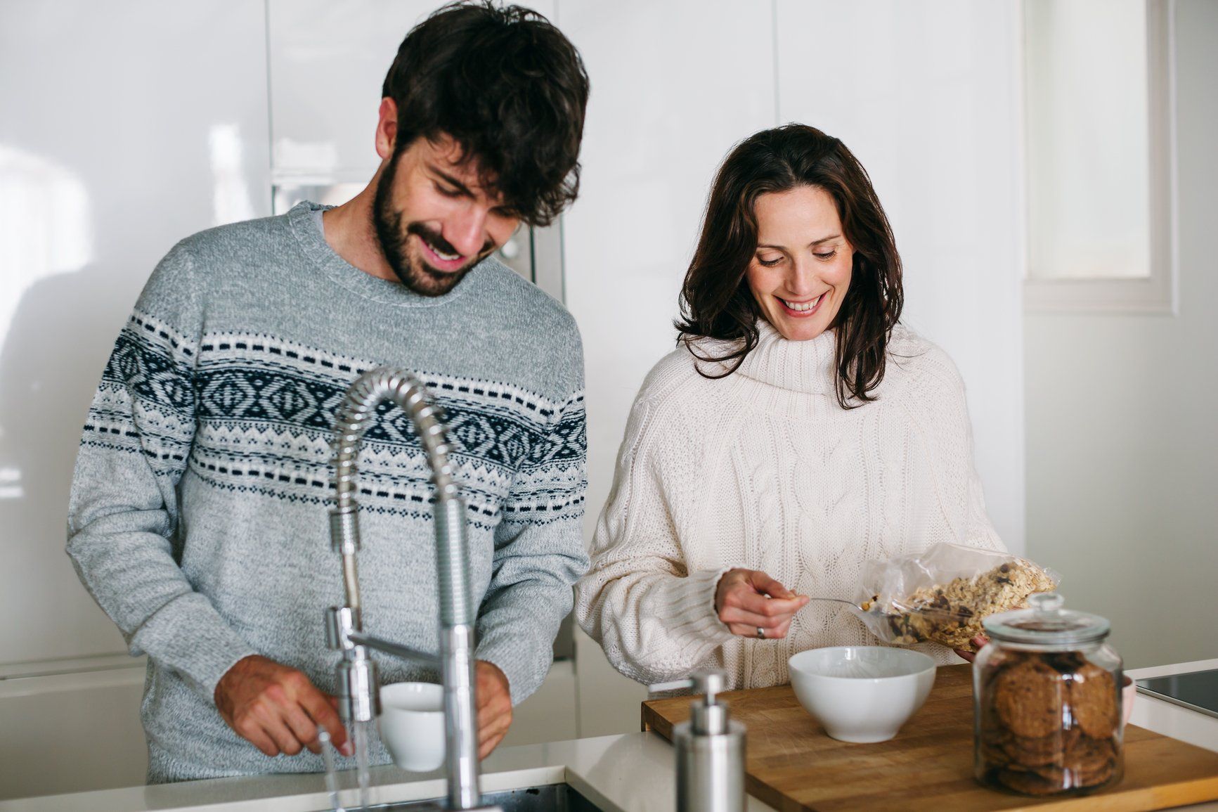 A couple cooking together in the kitchen.