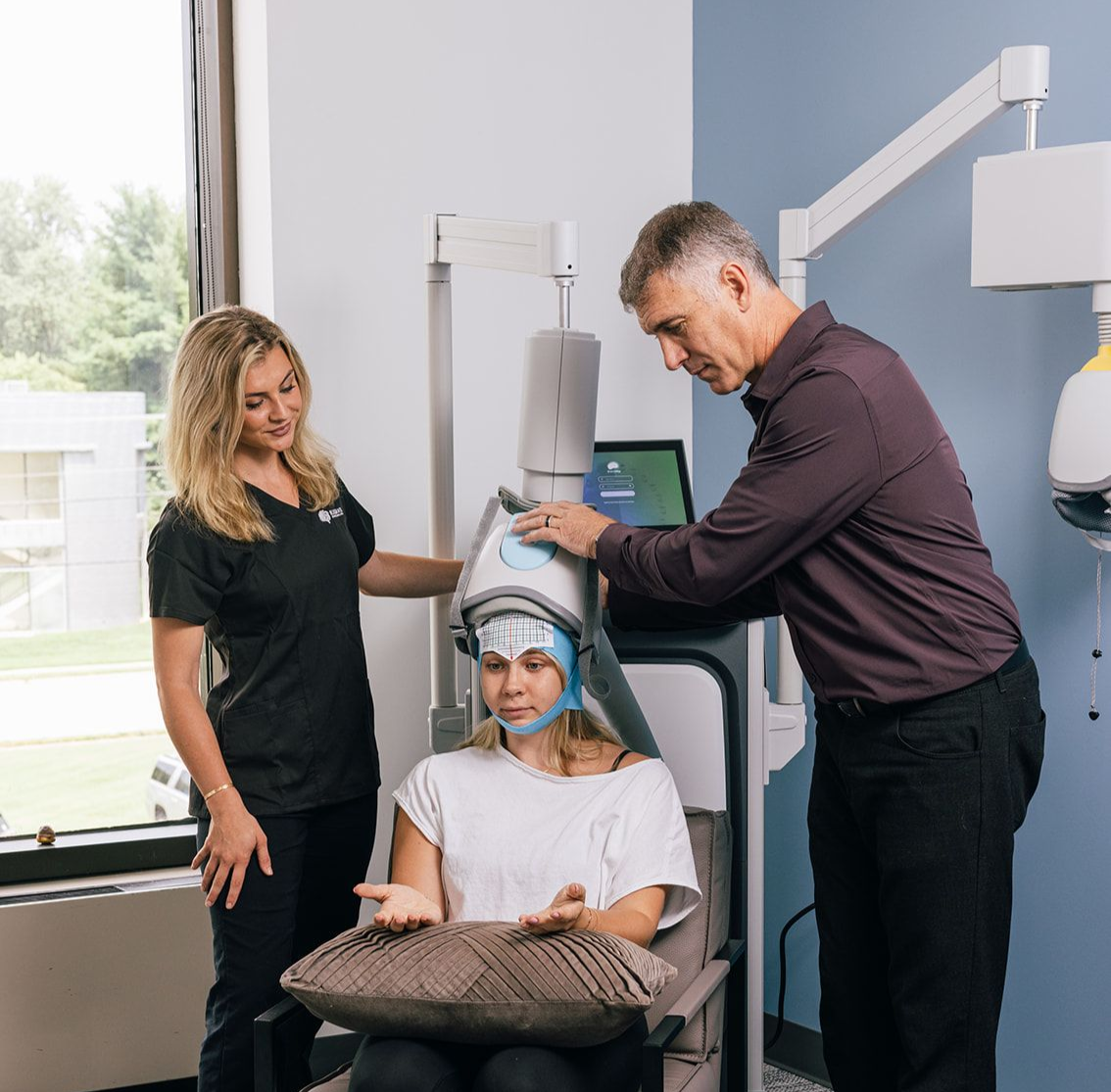 Dr. Roth and a team member demonstrating a TMS session,