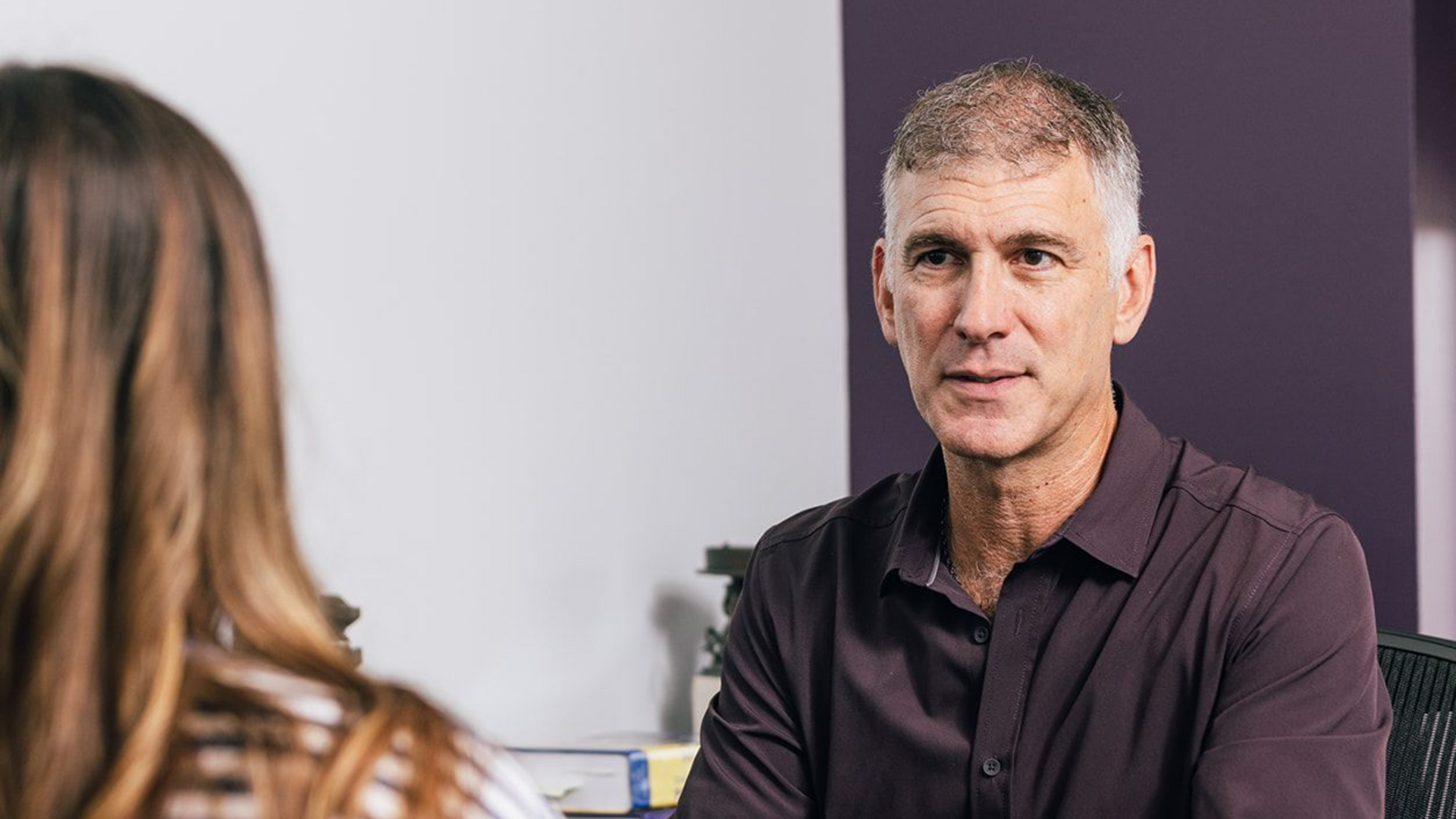 Dr. Roth explaining OCD to young adult patient.