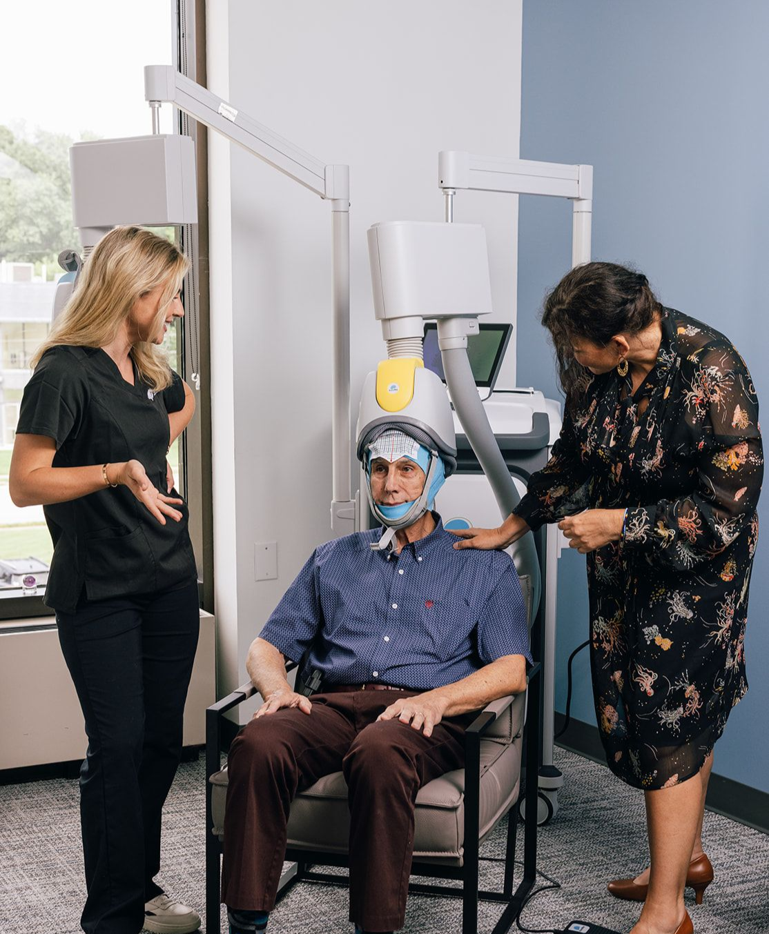 Older Man getting BrainsWay TMS for depression. Nurse Woods and Lead TMS Tech Alaina Sanders