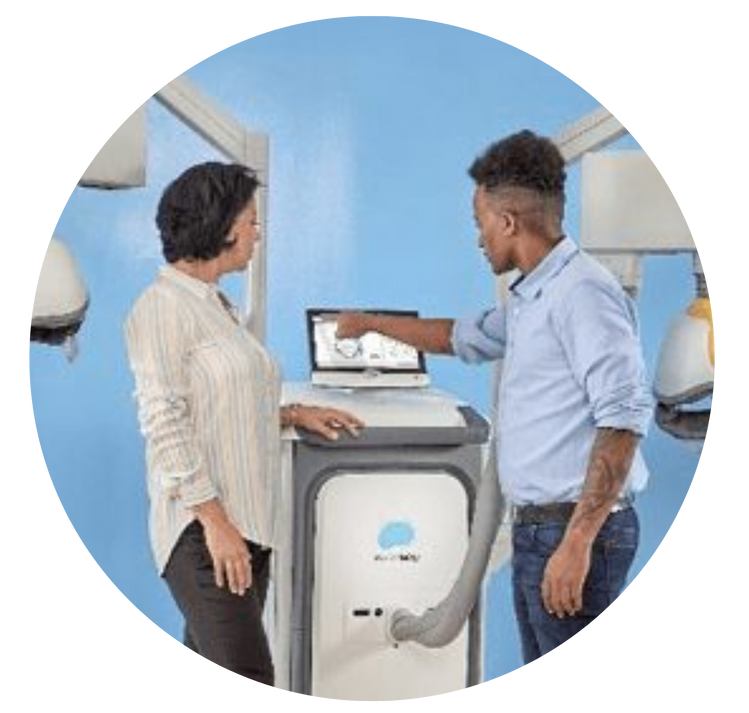 Two people in a blue room examining a washing machine with an open front panel.
