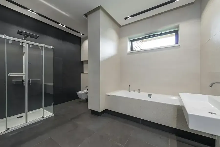 Minimal beige bathroom with vanity, large mirror, window blinds, and a potted plant
