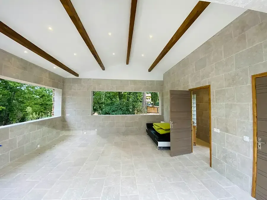 Minimal beige bathroom with vanity, large mirror, window blinds, and a potted plant