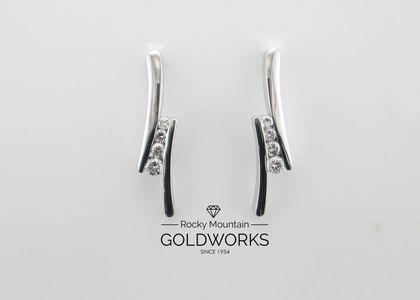 Silver and black curved earrings displayed above a Goldworks logo on a white background