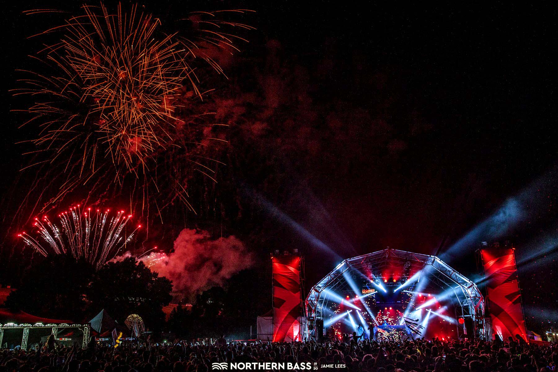 A crowd of people are watching fireworks at a concert Northern Bass