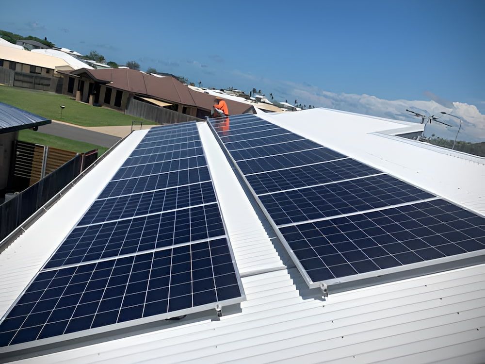 A Row Of Solar Panels On The Roof Of A Building — LV Energy Solutions in Gladstone, QLD