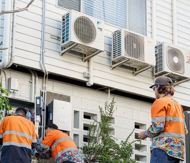 Workers Fixing Airconditioning — Levi's Electrics in Nerimbera, QLD