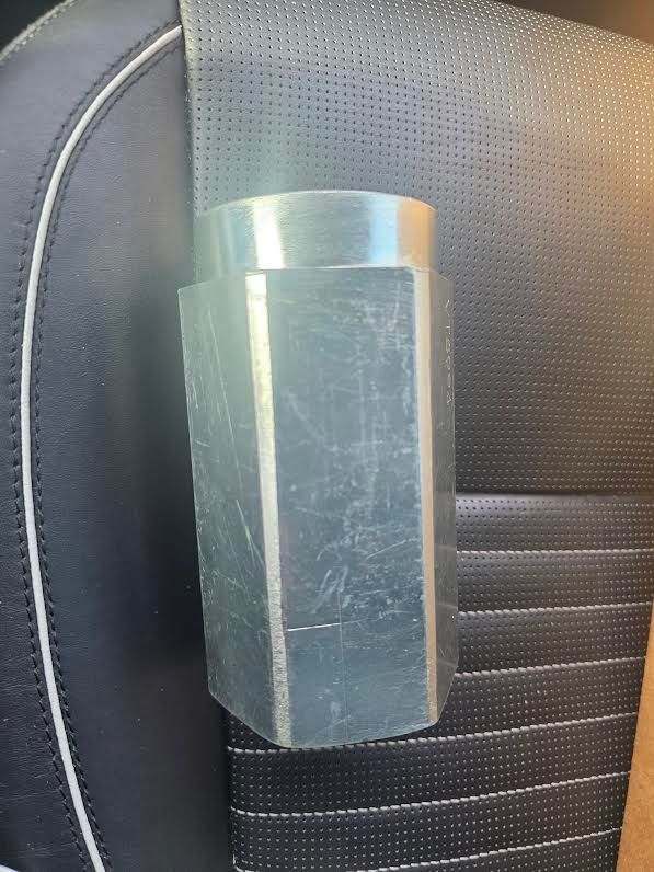 Silver hexagonal metal socket on a black car seat