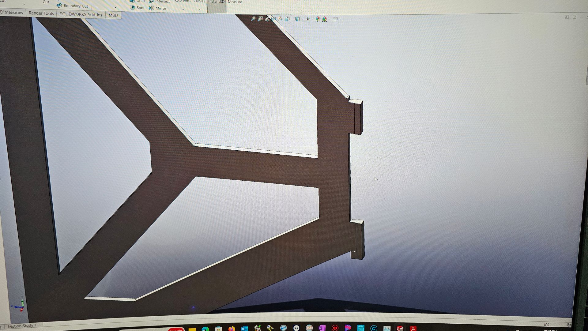 Brown angular wooden frame against a light background, resembling a geometric support structure