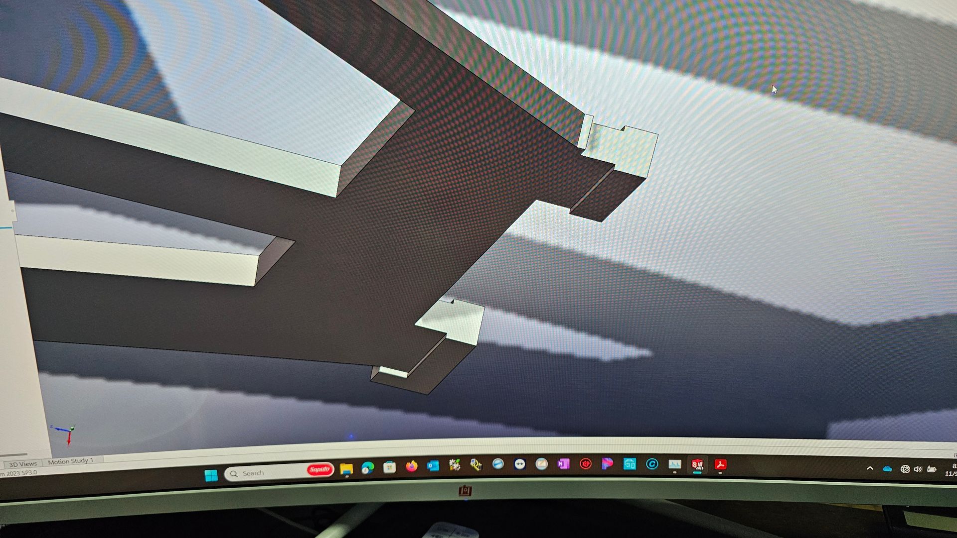 A 3D-rendered black aircraft or rocket-like shape viewed from below against a blue-gray sky.