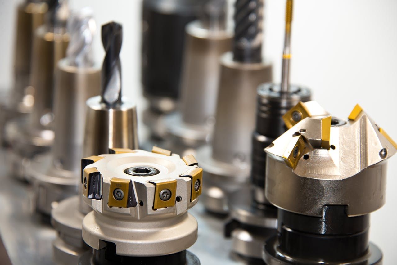 Assortment of metal machine tool cutting bits, in various shapes and sizes.