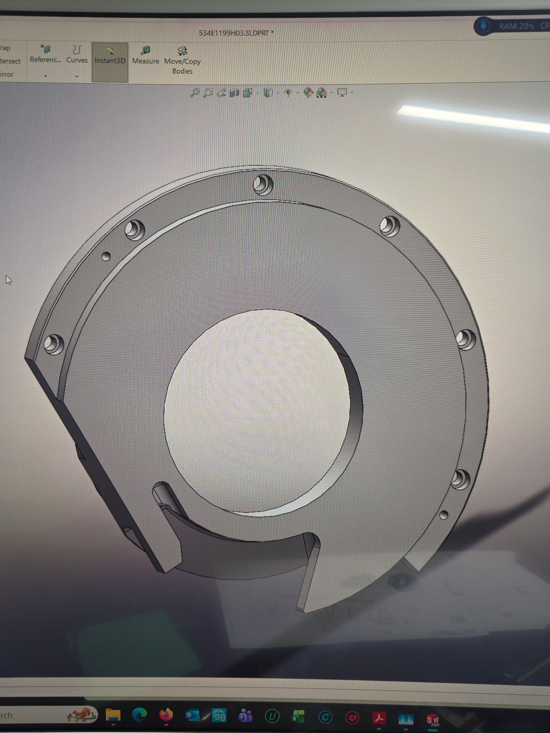 Gray mechanical ring or housing with a large circular opening, shown on a computer screen.