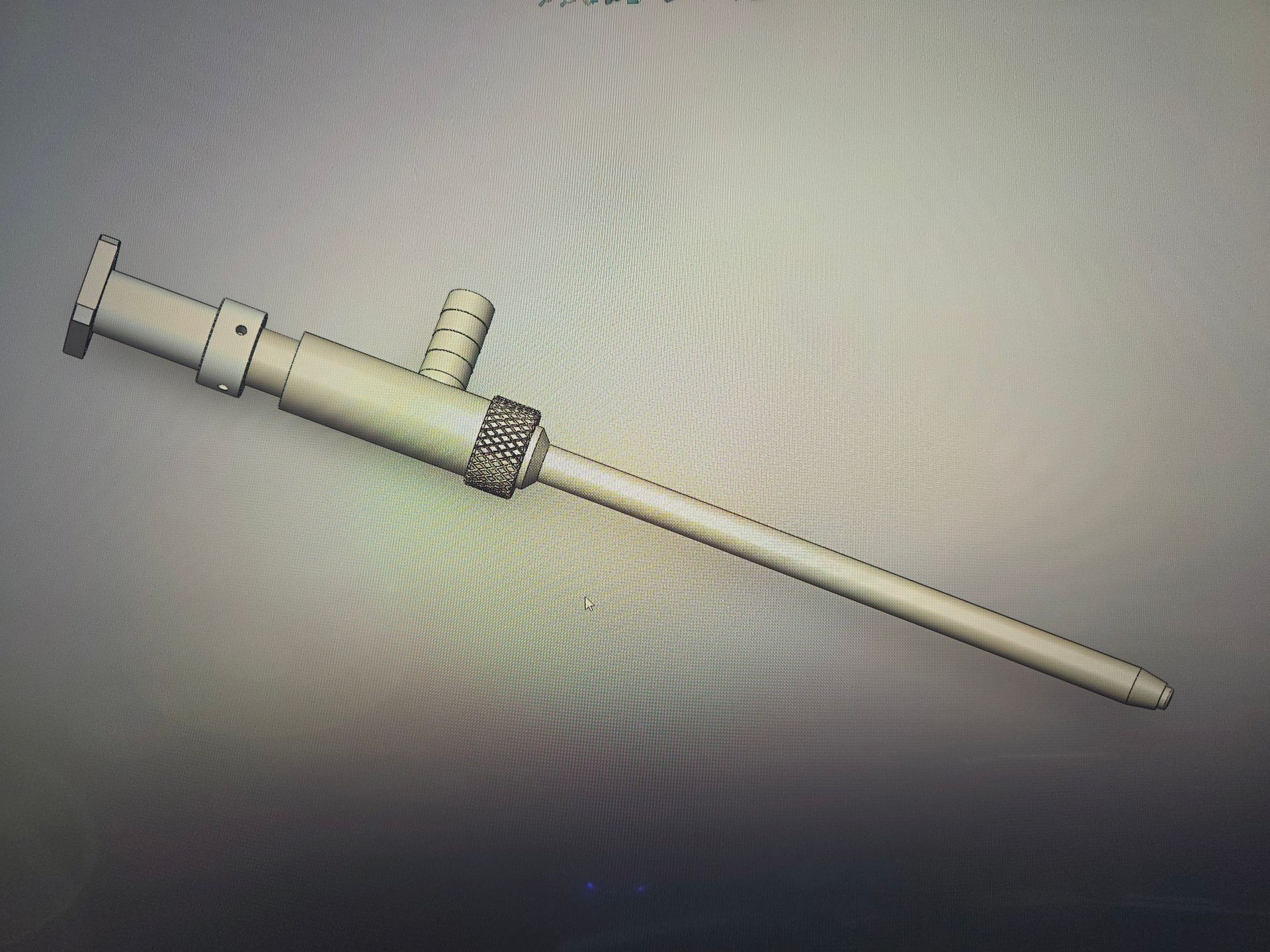 Syringe with a long needle and attached side port, shown on a plain background.
