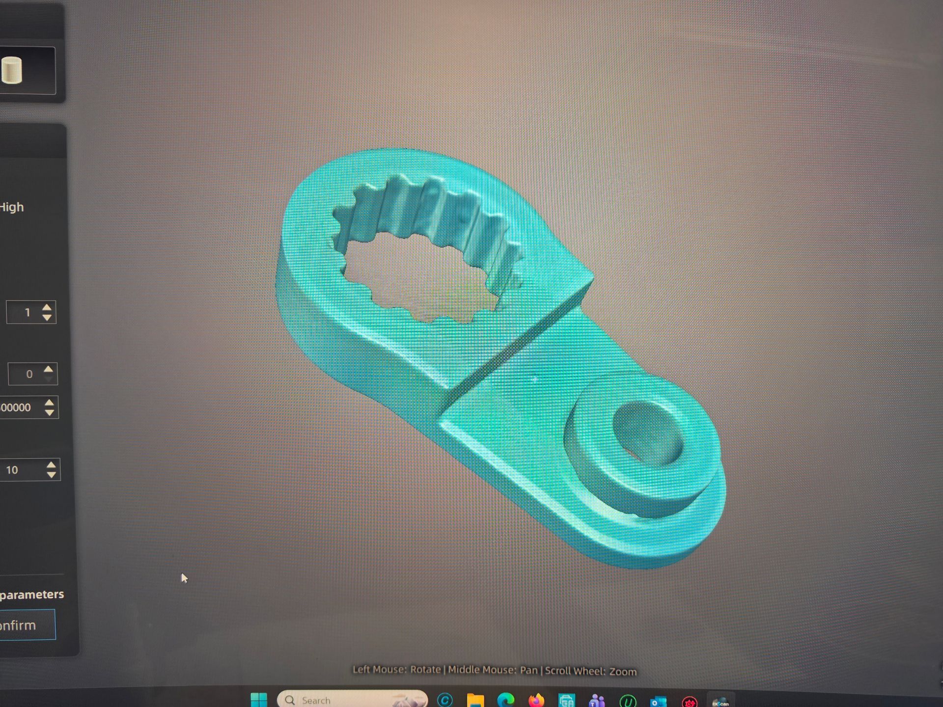 Turquoise 3D-rendered metal bracket with a circular hole and toothed opening on a CAD screen