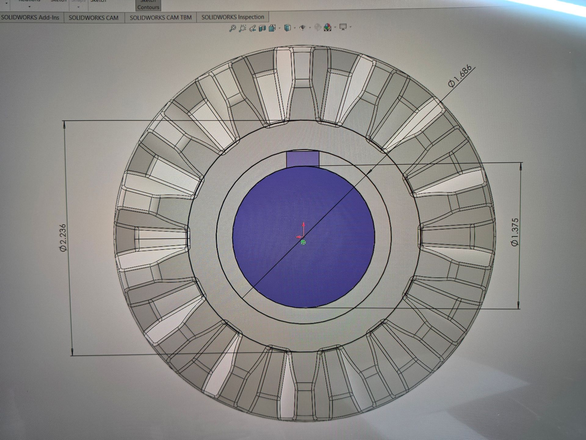 Circular technical diagram with a blue center and segmented gray outer ring, resembling a mechanical layout