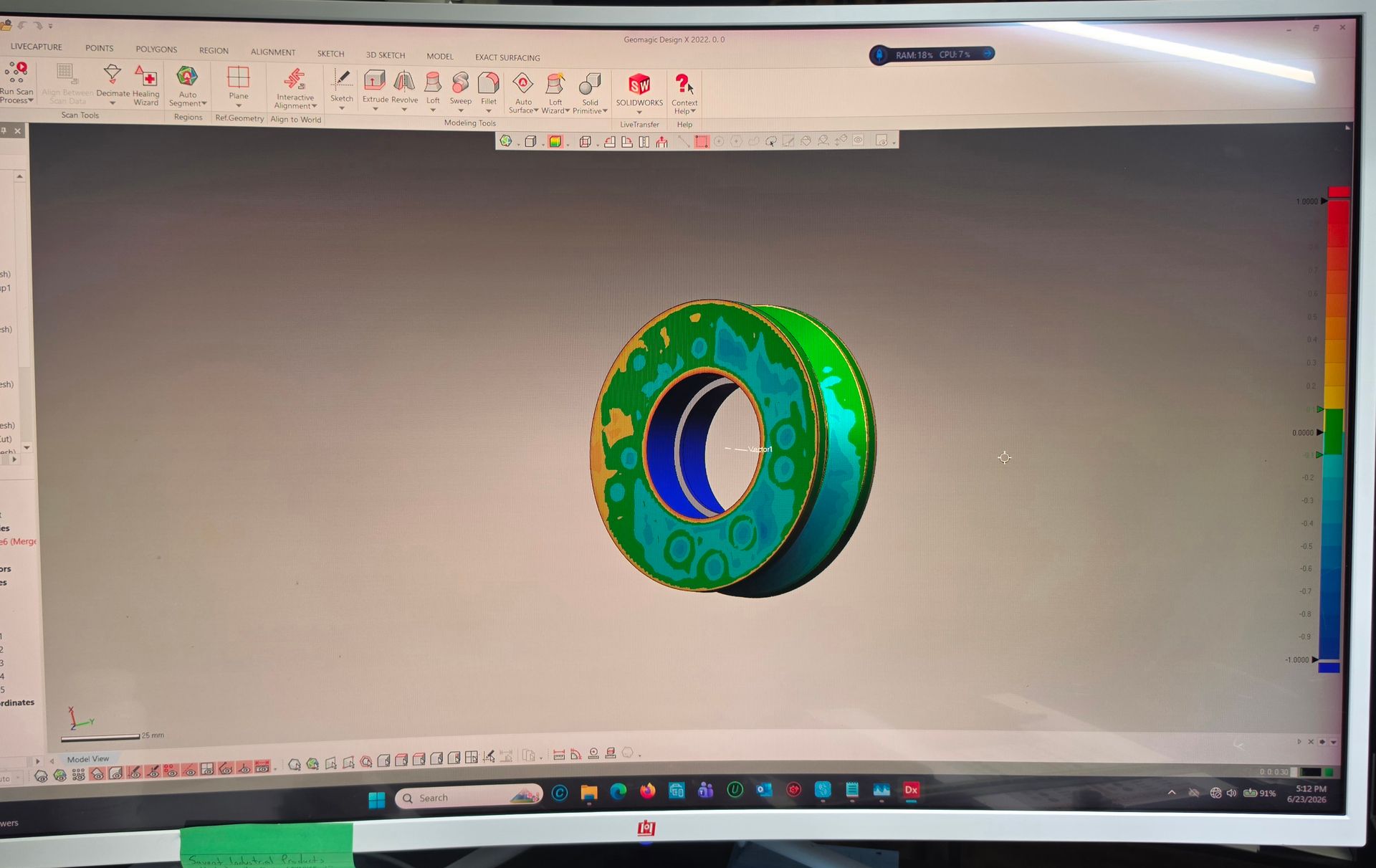 3D CAD model of a green gear-like ring displayed on a computer monitor
