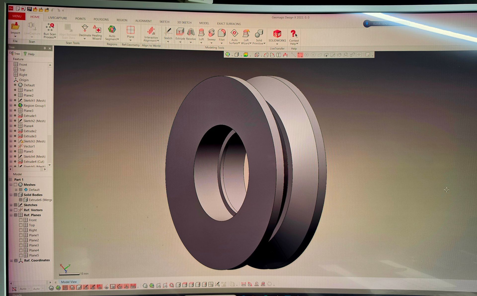 CAD software displaying a 3D model of a gray mechanical ring or wheel on screen