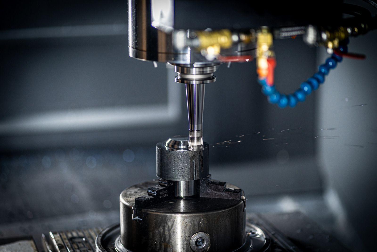 CNC machine milling a metal gear.