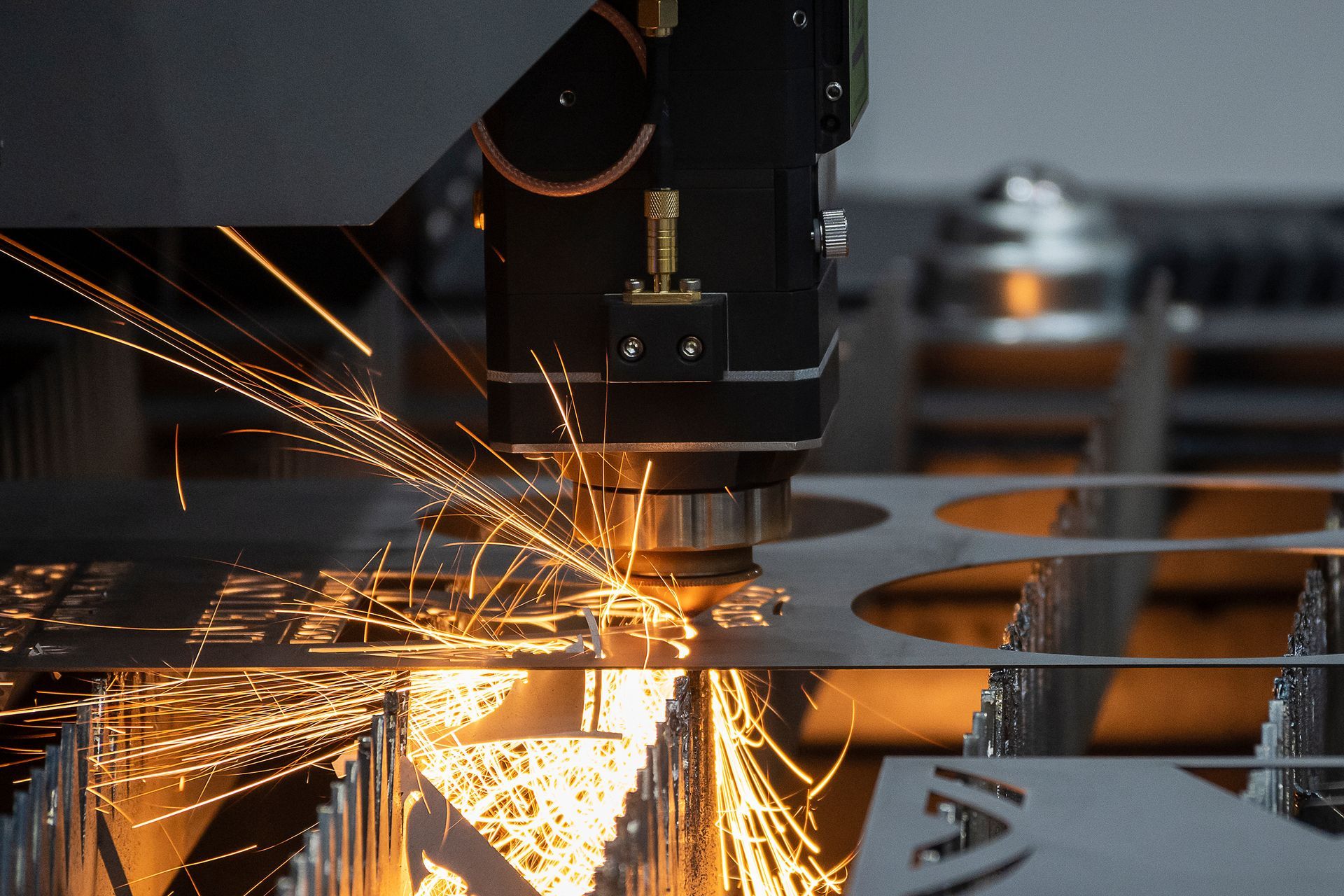 Laser cutting metal sheet with bright sparks in an industrial workshop Laser cutting metal sheet with bright sparks in an industrial workshop