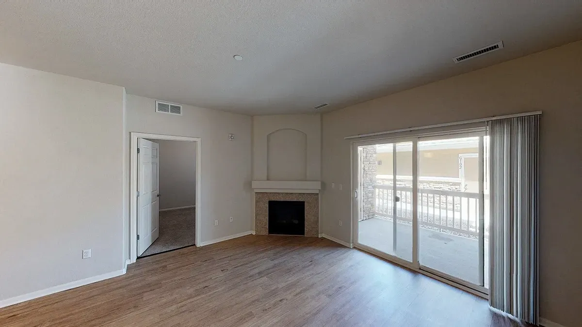 Living room with fireplace and balcony access