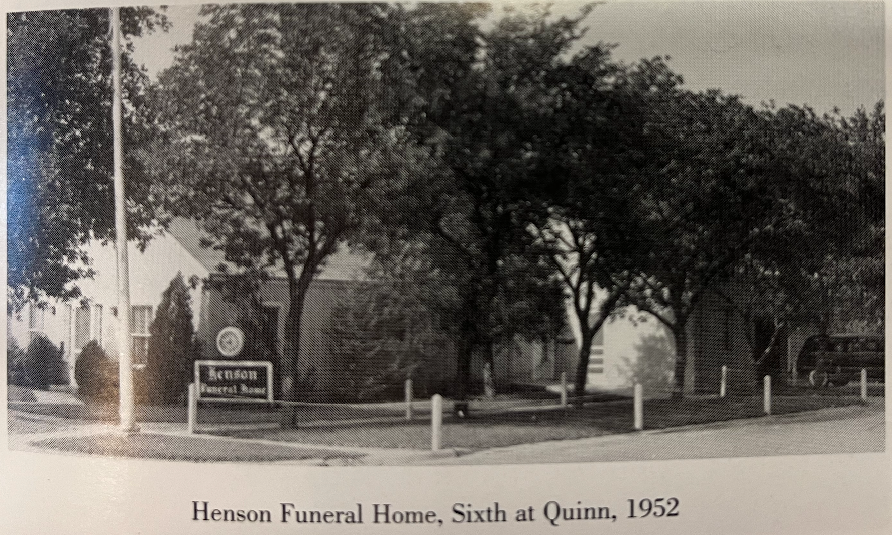 Hexon Funeral Home at Sixth and Quinn, 1952, with trees and a roadside sign.