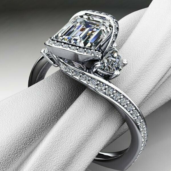 A diamond ring is sitting on a white cloth