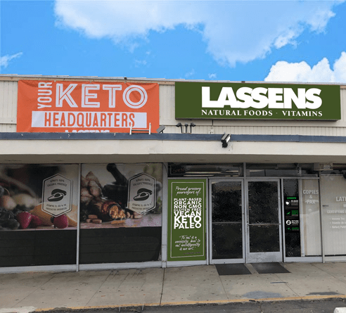 The storefront of Lassens Natural Foods and Vitamins with a large orange 