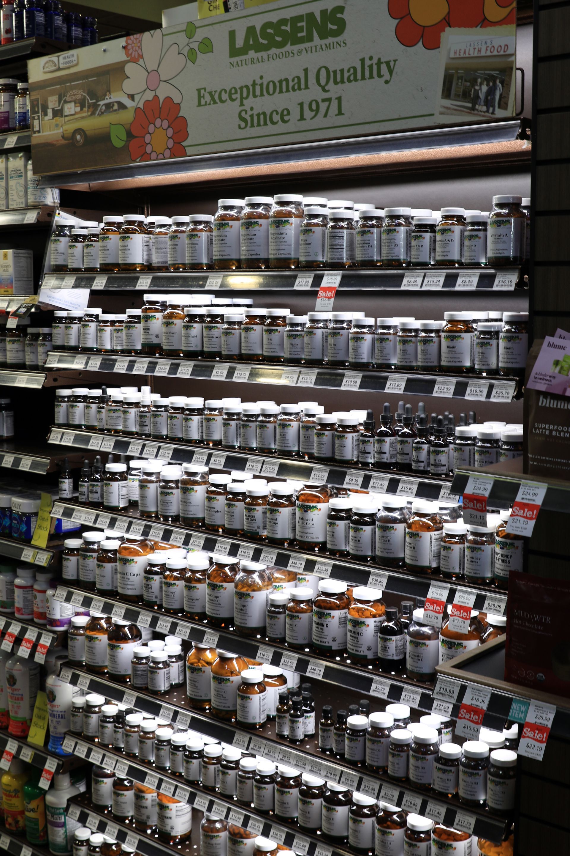 Retail display in a store featuring shelves filled with bottled skincare products and wooden accents.
