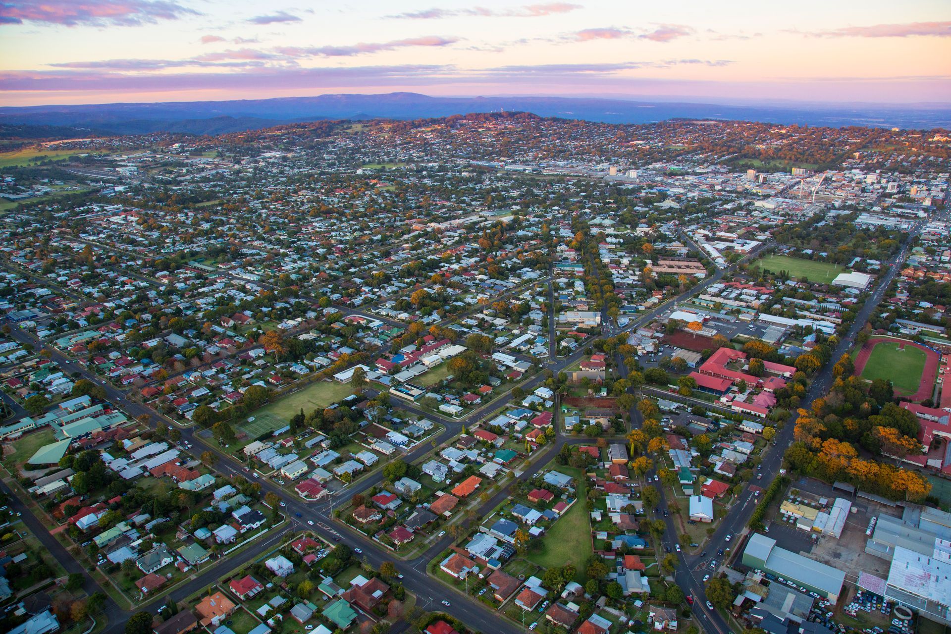 An aerial view of a city with lots of houses and buildings.