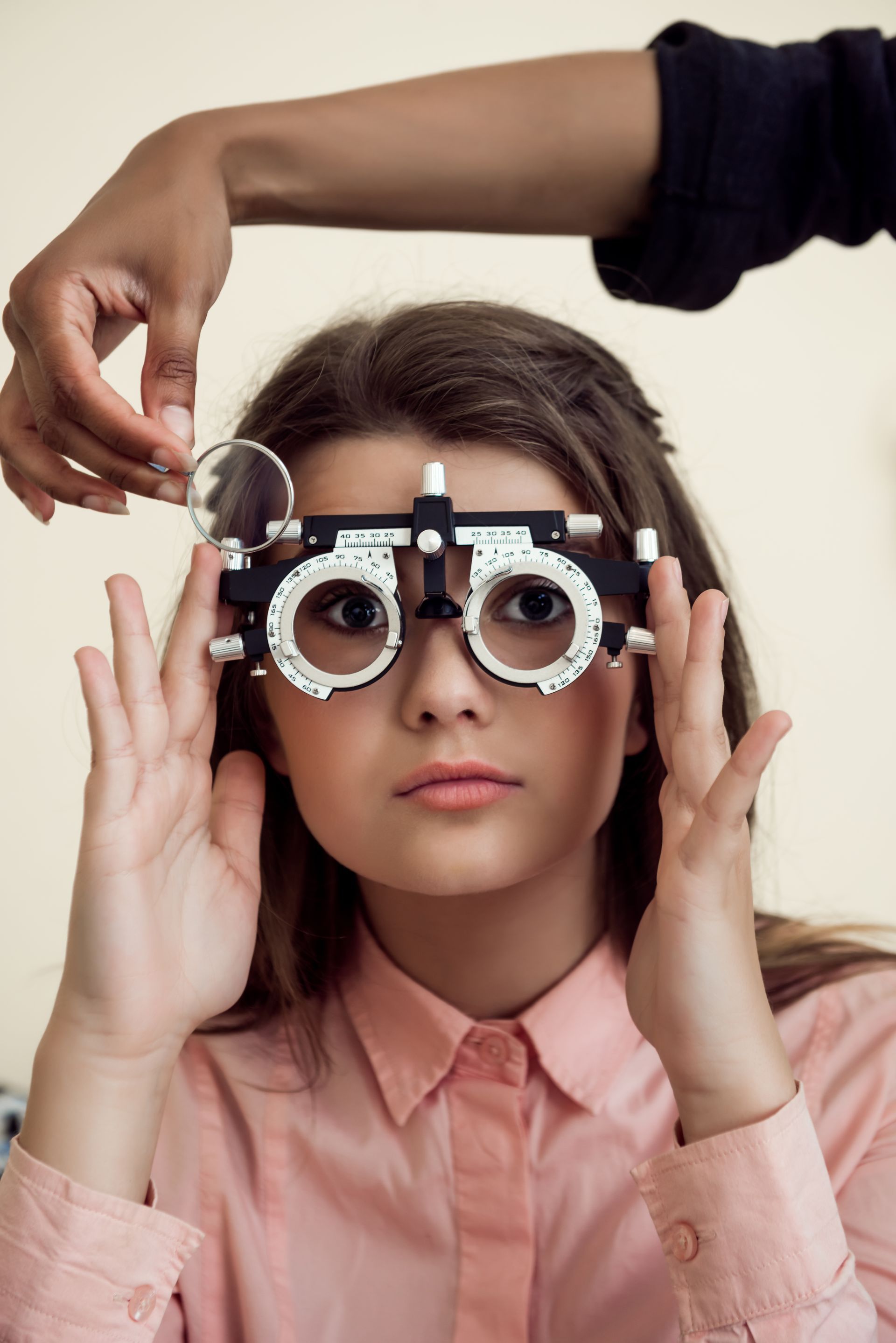A woman is getting her eyes checked by an ophthalmologist.