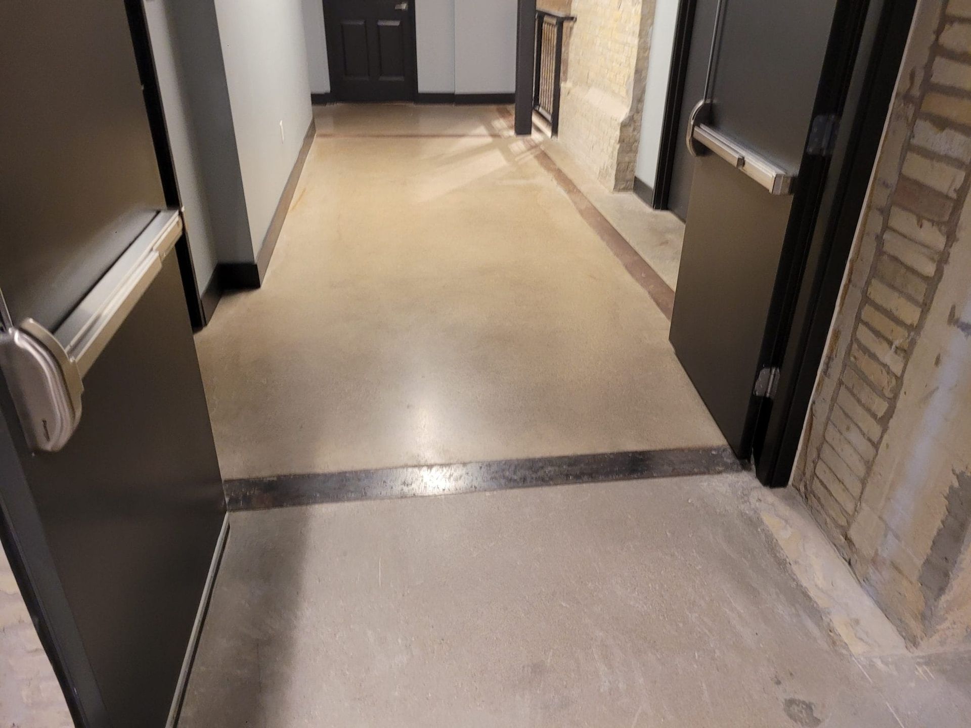 Indoor hallway with tan polished concrete.