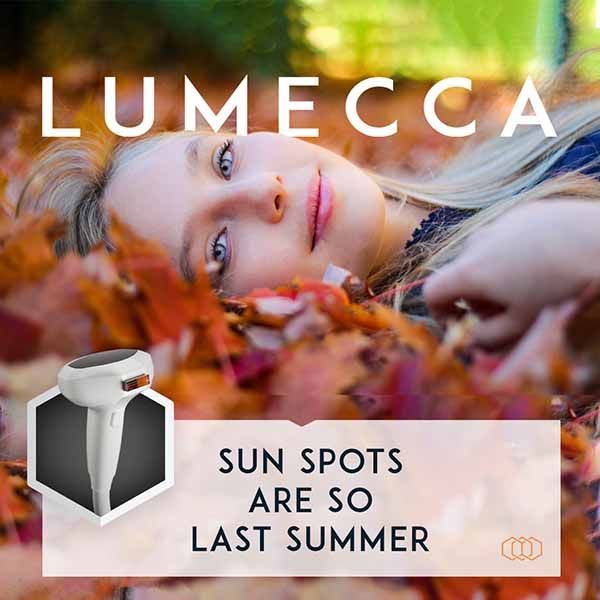 A woman laying on a pile of leaves with the words lumecca sun spots are so last summer