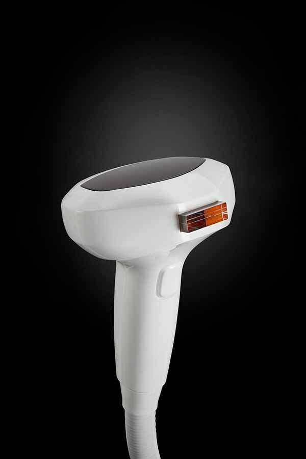 A close up of a hair removal device on a black background.