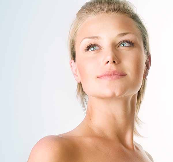 A close up of a woman 's face with a white background.