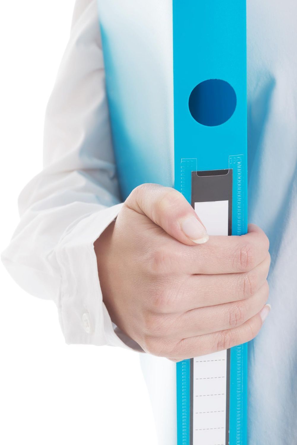 Person's hand holding a blue binder, wearing a white button-down shirt.